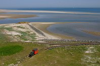 Strombauwerk  Kaum jemand kennt die kleine 600mm-spurige Bahn auf der künstlichen Insel Minsener Oog, die eigentlich nur von einem Vogelwart und den Mitarbeitern der Wasser- und Schifffahrtsverwaltung betreten werden darf. Durch lange Buhnen entstand das Strombauwerk, das die Versandung der Jade verhindert. Vom ausgedehnten Gleisnetz ist heute leider nur noch ein kleiner Rest vorhanden. Die kleine Diema-Lok zieht hier den winzigen Mannschaftswagen vom Anleger zu den Wohnbaracken (10. Mai 2006). : DIEMA, FNr 1894 Diema, M, Minsener Oog, a Aufnahmeort, a Deutschland, e Eisenbahn, ef Hersteller