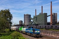 km 13,2  Gleiche Stelle, nun aber etwas seitlicher und vom Hochstativ aus fotografiert:  Am 22. Juli 2019 war die NIAG-Lok 1 gemeinsam mit der Mietlok 4180 001 – eine der wenigen dieselhydraulischen DH 18 von Vossloh – auf der Emschertalbahn vor einem langen Ganzzug im Einsatz. Links über der zweiten Lok sind die gewaltigen Kohleberge zu sehen, die hier verarbeitet werden. : 92 80 1277 (G 1700), 92 80 4180 (Vossloh G 18), NIAG, Str 2206 WAN - OB-Sterkrade, a - Aufnahmeort, a Deutschland, ao Bottrop, ao Bottrop-Welheim Kokerei Prosper, eb NIAG 1'', ef 5001535 Vossloh (2004), ef 5001927 Vossloh (2011), en 92 80 1277 804-1, en 92 80 4180 001-4, es 2206 km 13-3